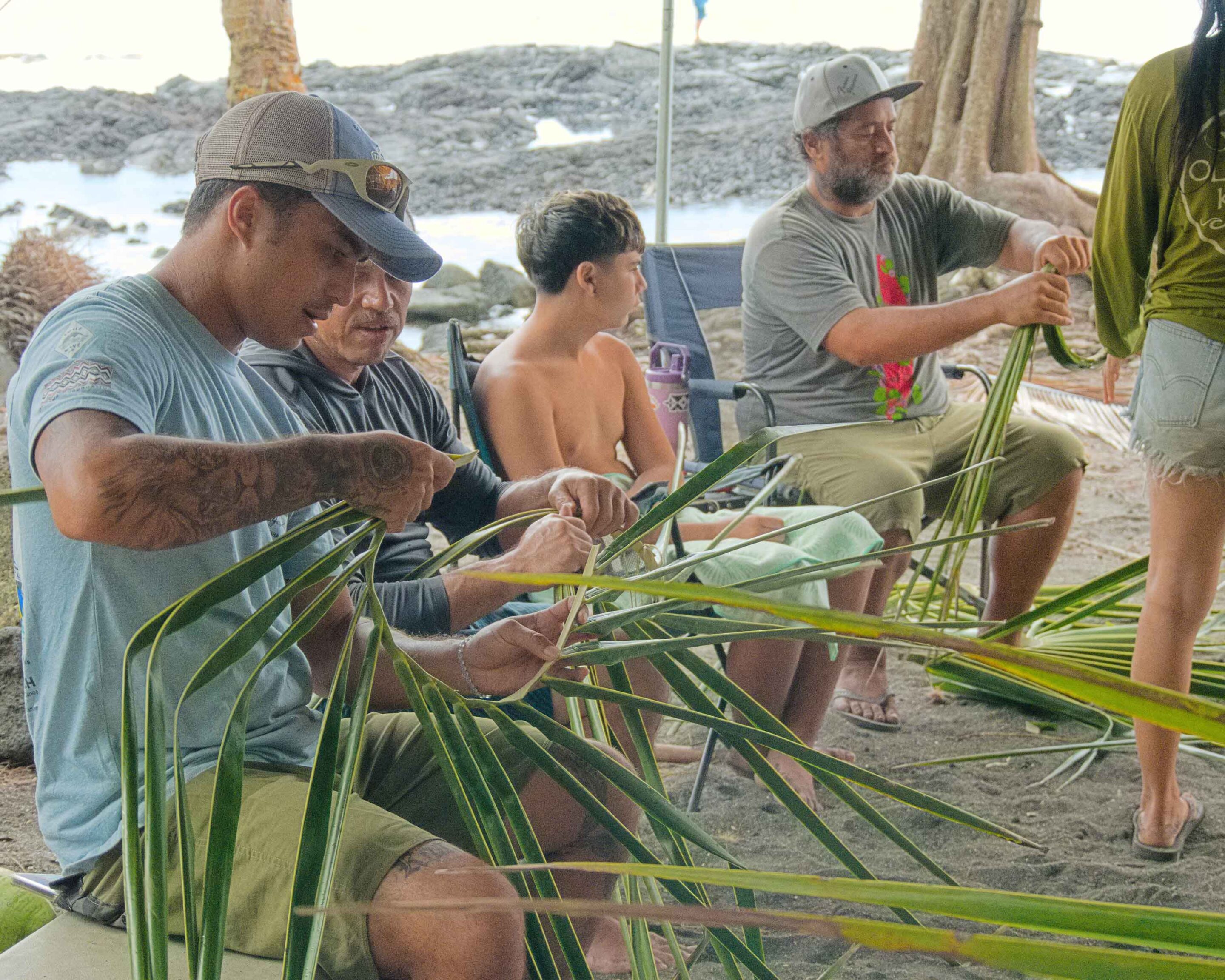 Indrajit and Dr. Roland with coconuts Jit is throwing down from tree ho'owehe-workshops-12